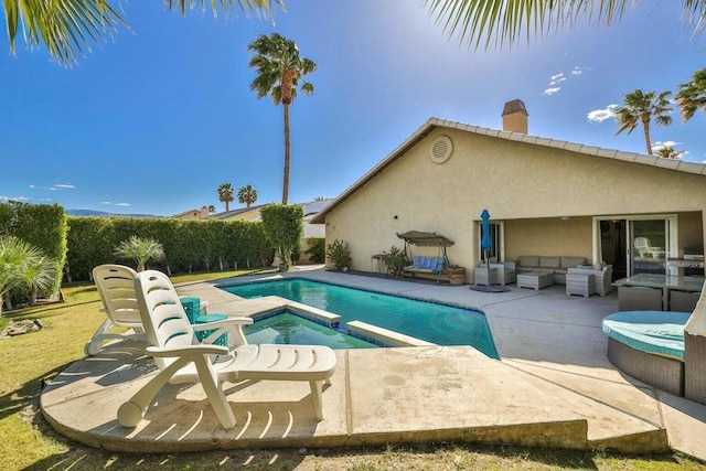 view of swimming pool with an outdoor living space and a patio