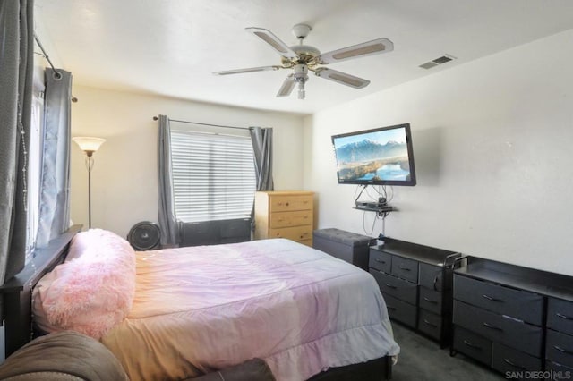 bedroom with ceiling fan and dark carpet