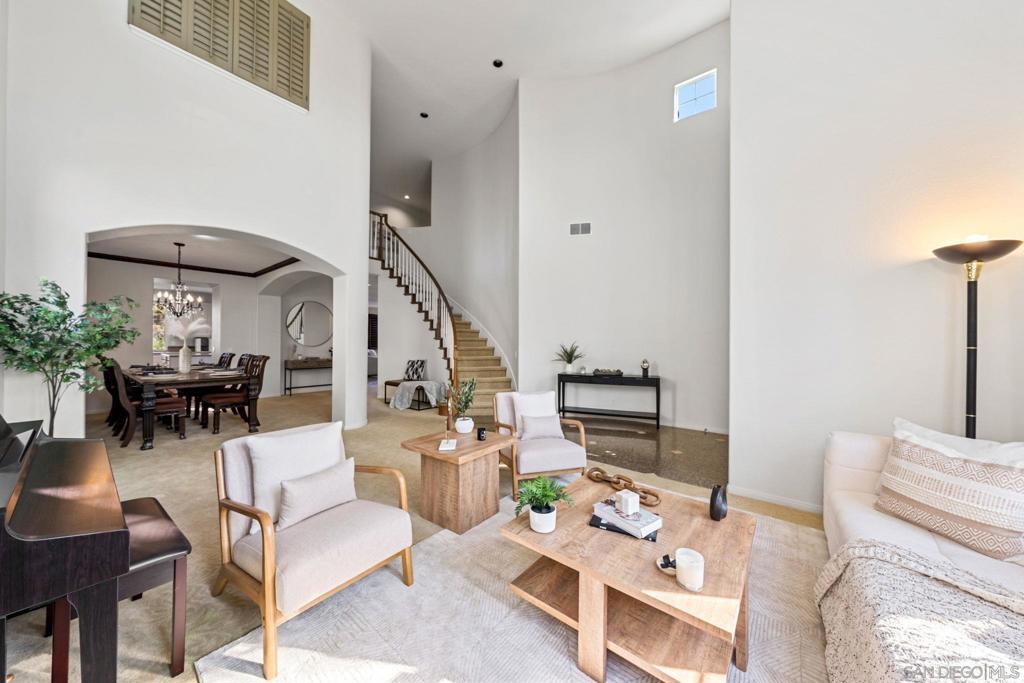 living room with a high ceiling and an inviting chandelier