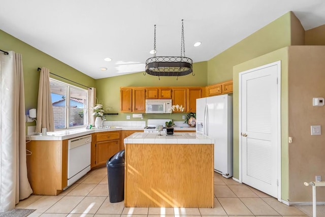 kitchen with white appliances, tile countertops, a center island, and light tile patterned floors