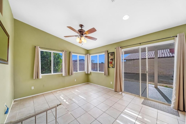 spare room featuring light tile patterned floors, vaulted ceiling, and ceiling fan