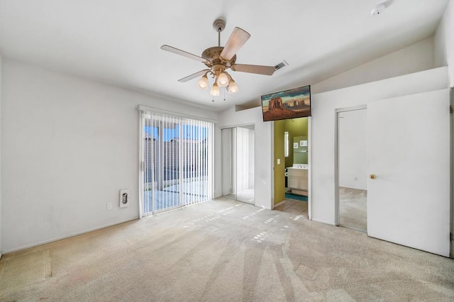 unfurnished bedroom featuring lofted ceiling, connected bathroom, light carpet, ceiling fan, and access to exterior