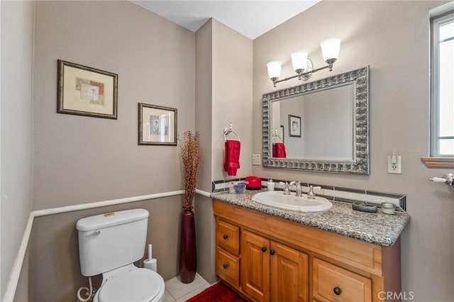 bathroom featuring vanity, tile patterned flooring, and toilet