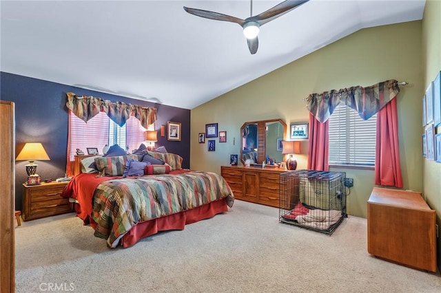 carpeted bedroom featuring multiple windows, vaulted ceiling, and ceiling fan