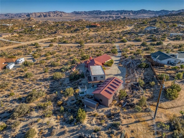 birds eye view of property with a mountain view