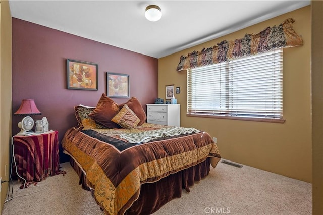 bedroom featuring light carpet