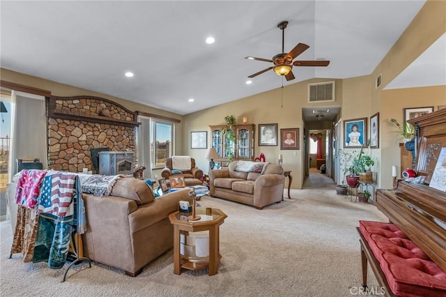 carpeted living room featuring ceiling fan, lofted ceiling, and a fireplace