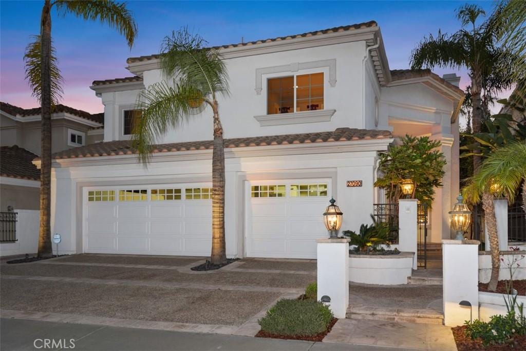 mediterranean / spanish-style house with a garage