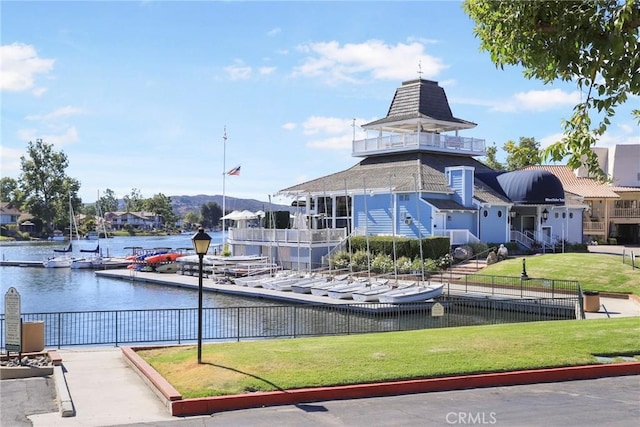 view of community with a water view and a lawn