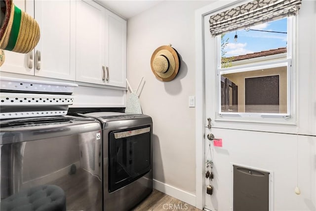 laundry room with cabinets, separate washer and dryer, and hardwood / wood-style floors