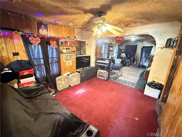 interior space with ceiling fan and a textured ceiling