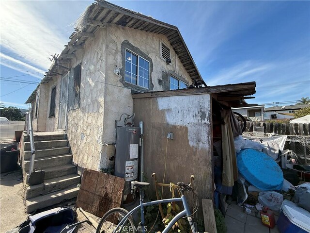 view of side of home featuring water heater