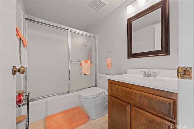 full bathroom featuring enclosed tub / shower combo, toilet, tile patterned floors, and vanity