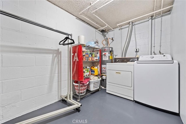 washroom featuring water heater and separate washer and dryer