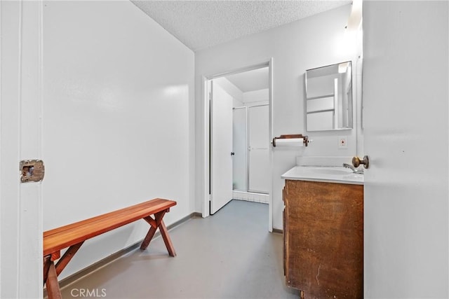 bathroom featuring vanity, concrete floors, and a textured ceiling