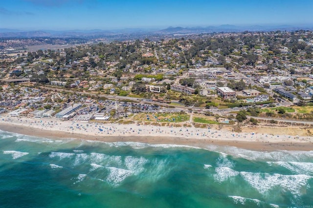 bird's eye view featuring a water view and a beach view