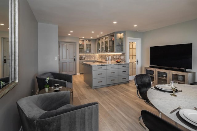 living room featuring bar and light hardwood / wood-style flooring