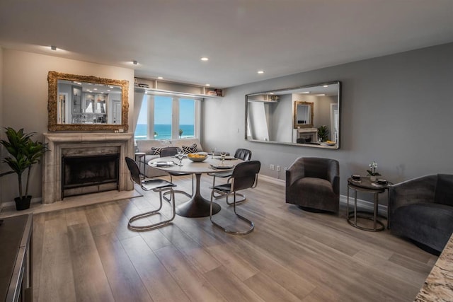 dining space featuring wood-type flooring and a water view