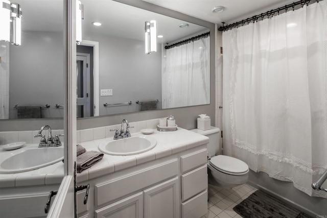 full bathroom featuring shower / tub combo with curtain, vanity, tile patterned flooring, and toilet