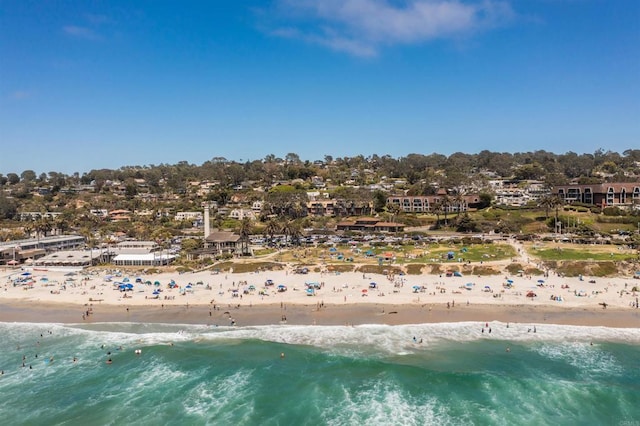 drone / aerial view featuring a water view and a beach view