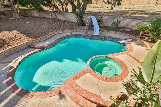 20591 Celtic St, Chatsworth, CA 91311 - view of pool featuring a pool with connected hot tub, a fenced backyard, and a water slide