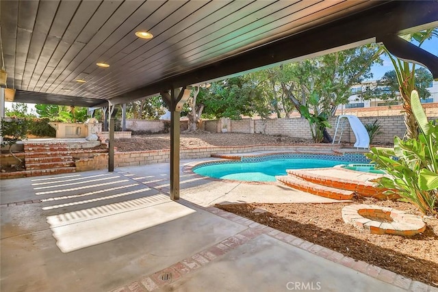 20591 Celtic St, Chatsworth, CA 91311 - view of pool featuring a fenced in pool, a fenced backyard, a water slide, and a patio area