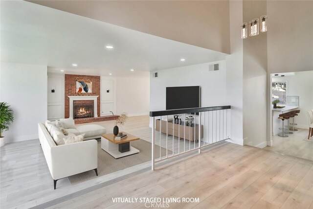 20591 Celtic St, Chatsworth, CA 91311 - living area featuring baseboards, visible vents, wood finished floors, and a fireplace