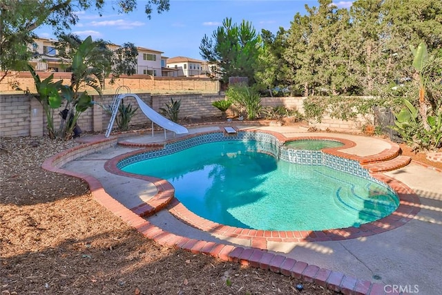 20591 Celtic St, Chatsworth, CA 91311 - view of pool featuring an in ground hot tub, a fenced backyard, a water slide, and a fenced in pool