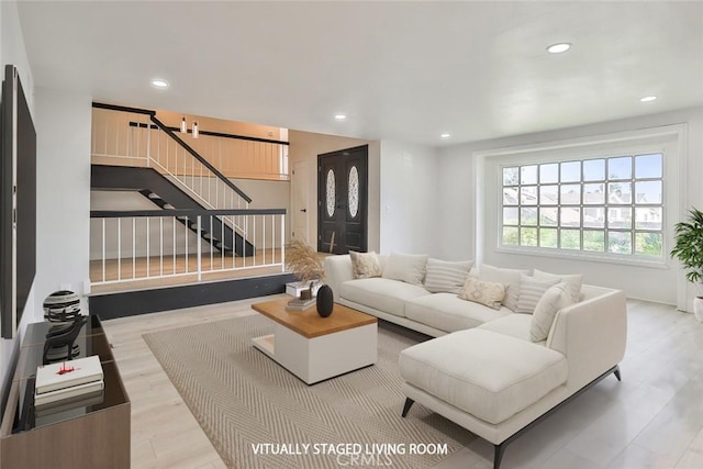 20591 Celtic St, Chatsworth, CA 91311 - living room featuring wood finished floors, recessed lighting, and stairs