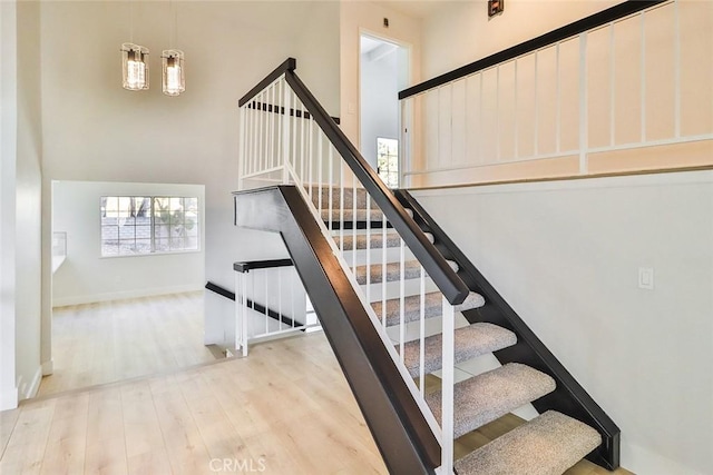 20591 Celtic St, Chatsworth, CA 91311 - staircase with wood finished floors, baseboards, and a high ceiling