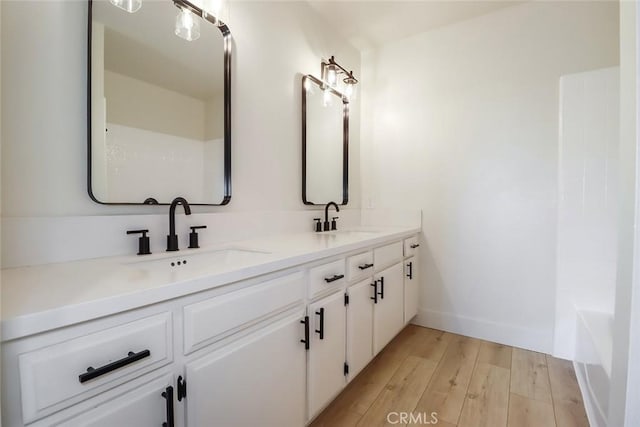 20591 Celtic St, Chatsworth, CA 91311 - full bathroom featuring double vanity, wood finished floors, baseboards, and a sink