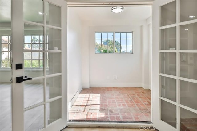 20591 Celtic St, Chatsworth, CA 91311 - entryway with plenty of natural light, brick floor, and baseboards
