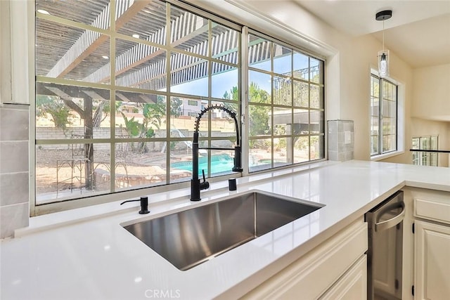 20591 Celtic St, Chatsworth, CA 91311 - kitchen with a sink, a healthy amount of sunlight, decorative light fixtures, light countertops, and stainless steel dishwasher