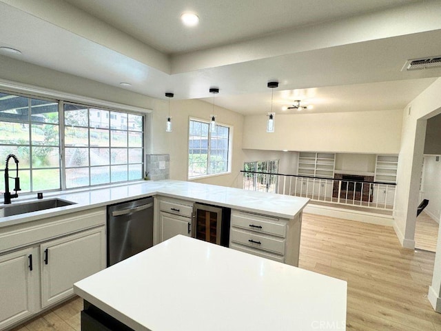 20591 Celtic St, Chatsworth, CA 91311 - kitchen featuring a sink, wine cooler, light wood-type flooring, light countertops, and dishwasher