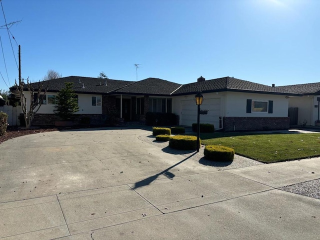 single story home featuring a garage and a front lawn