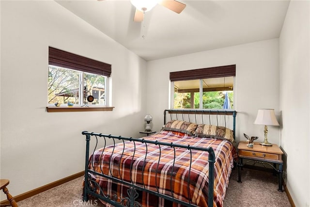 carpeted bedroom with multiple windows and ceiling fan