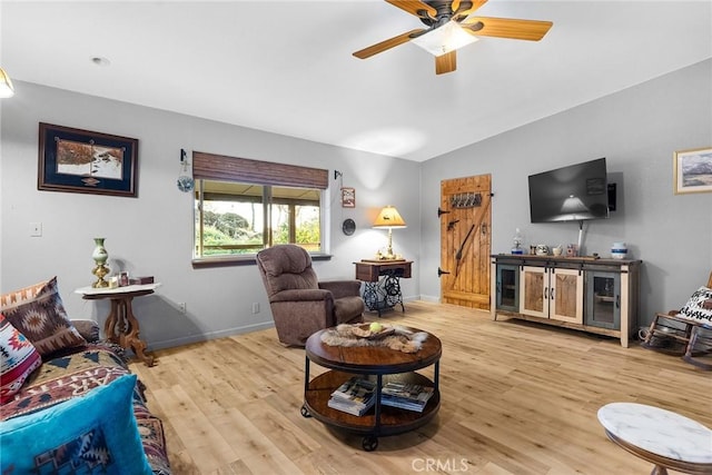 living room with hardwood / wood-style flooring and ceiling fan