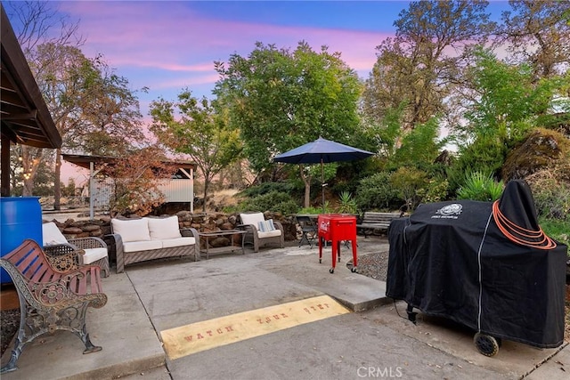 patio terrace at dusk featuring area for grilling and an outdoor hangout area