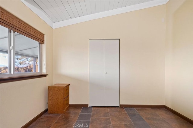 unfurnished bedroom featuring vaulted ceiling, wood ceiling, and a closet