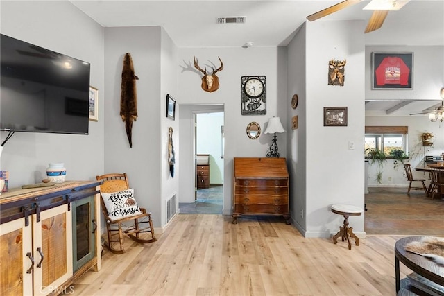 interior space featuring ceiling fan and light wood-type flooring