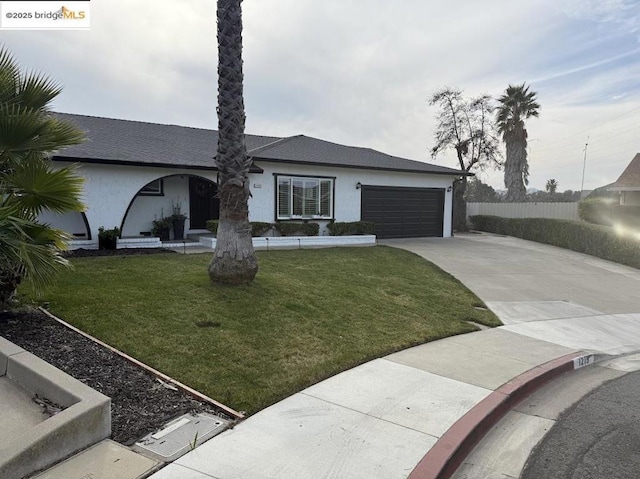 single story home with a garage and a front yard