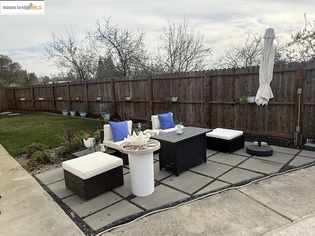 view of patio featuring an outdoor living space with a fire pit