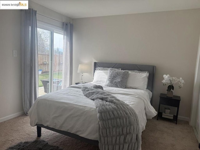 carpeted bedroom featuring access to outside