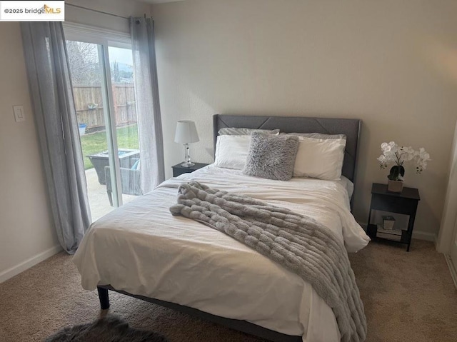 bedroom with carpet flooring and access to outside