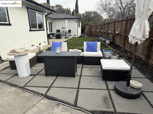 view of patio / terrace featuring an outdoor living space with a fire pit