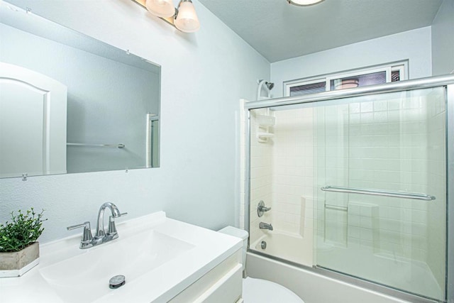 full bathroom with toilet, combined bath / shower with glass door, and vanity