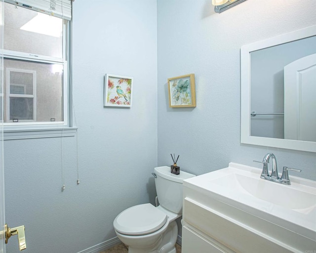 bathroom featuring toilet and vanity