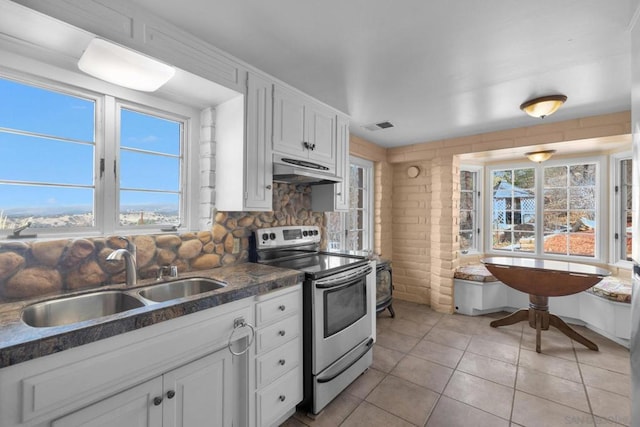 kitchen with white cabinetry, sink, electric range, and a healthy amount of sunlight