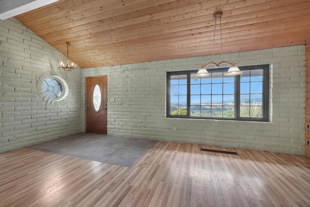 foyer entrance featuring brick wall, hardwood / wood-style floors, lofted ceiling, wooden ceiling, and an inviting chandelier