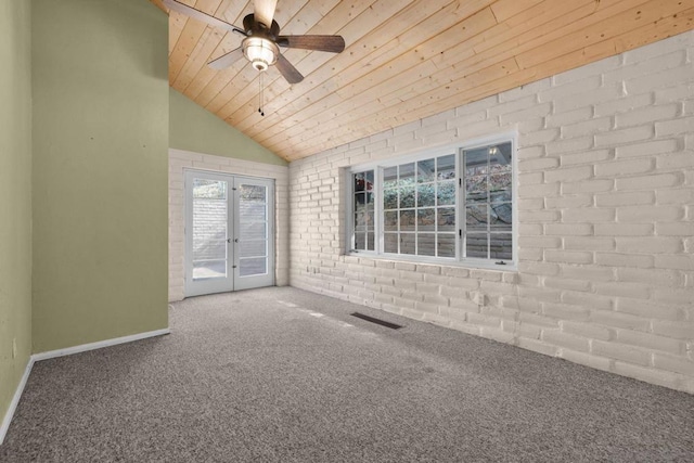 unfurnished room with wood ceiling, carpet, brick wall, vaulted ceiling, and french doors